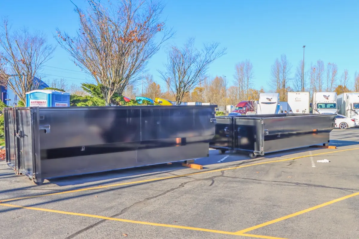 Professional dumpster rental service with roll-off container on residential driveway in St. George